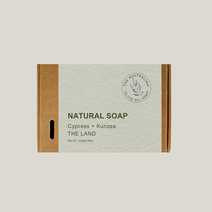 Box of natural soap with 'The Land' branding on a light beige background