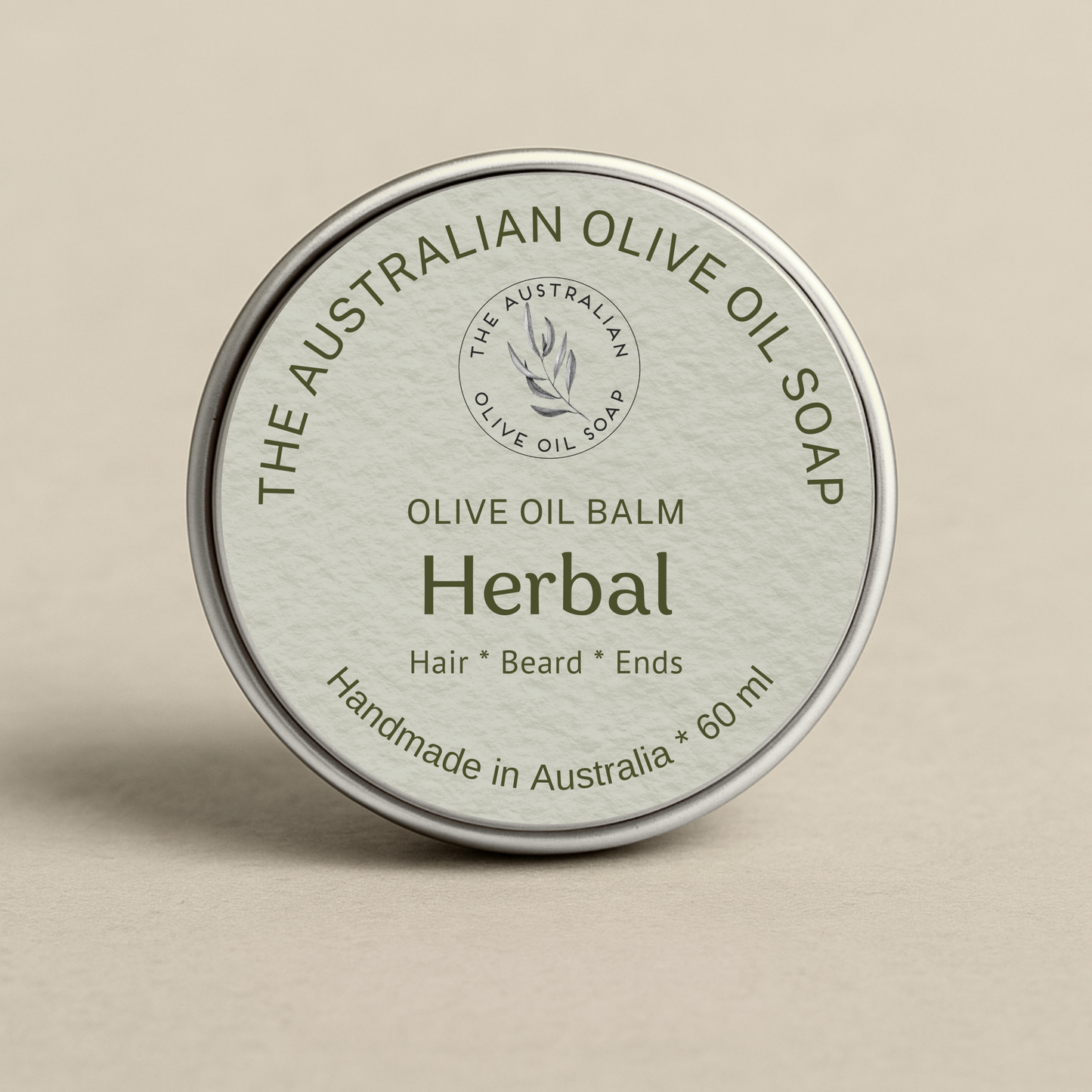 Olive oil balm container with 'The Australian Olive Oil Soap' branding on a beige background