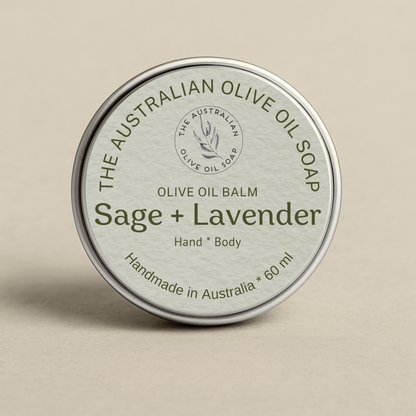 Olive oil balm tin labeled 'Sage + Lavender' from The Australian Olive Oil Soap on a beige background