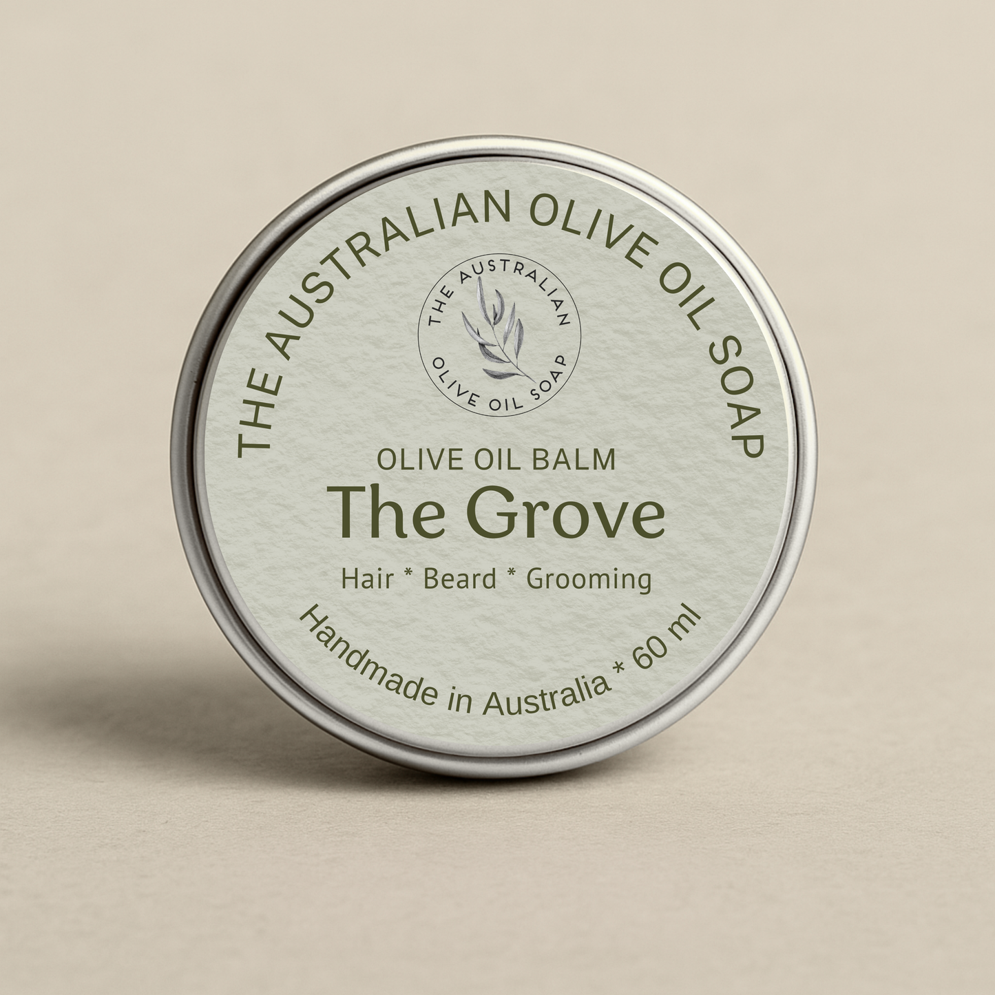 Olive oil balm container labeled 'The Grove' on a beige background